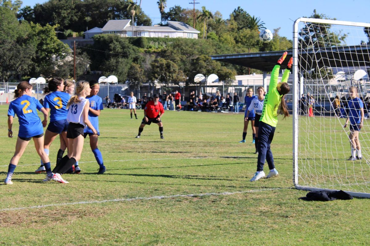 Lacey White scores from a shot above the goalkeepers head
